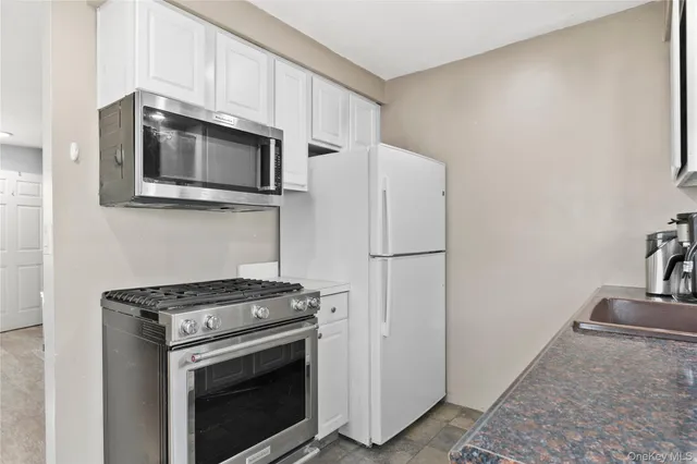 a stove top oven sitting inside of a kitchen