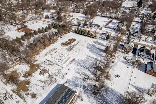 an aerial view of a house with a yard