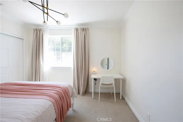 a bedroom with a bed and a wooden floor