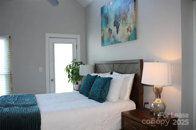 a bedroom with a bed and a painting on the wall