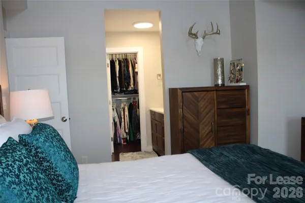 a bedroom with a bed and a walk in closet