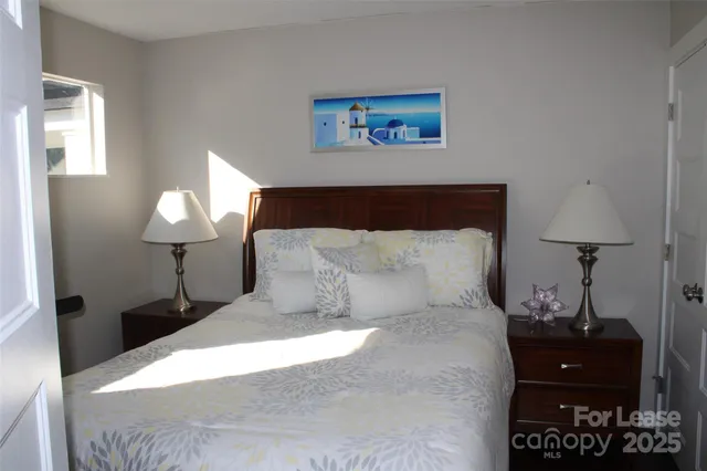 a bed room with a bed and a lamp