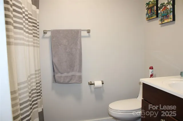 a white toilet sitting next to a bathroom sink