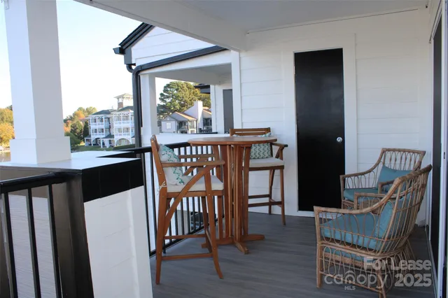 a view of a hallway with wooden floor and stairs