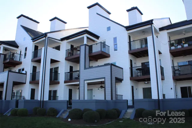 a front view of a residential apartment building with a yard