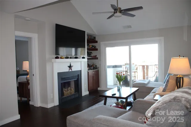 a living room with furniture a large window and a flat screen tv