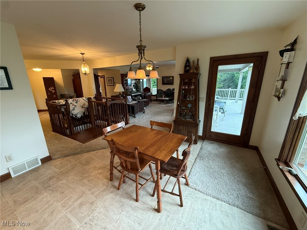 2597 Pyle Road Dover, OH 44622 - Photo 16 of 50 Dining room featuring light colored carpet and baseboards