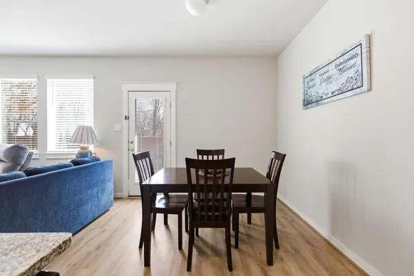 a view of a dining room with furniture a livingroom and wooden floor