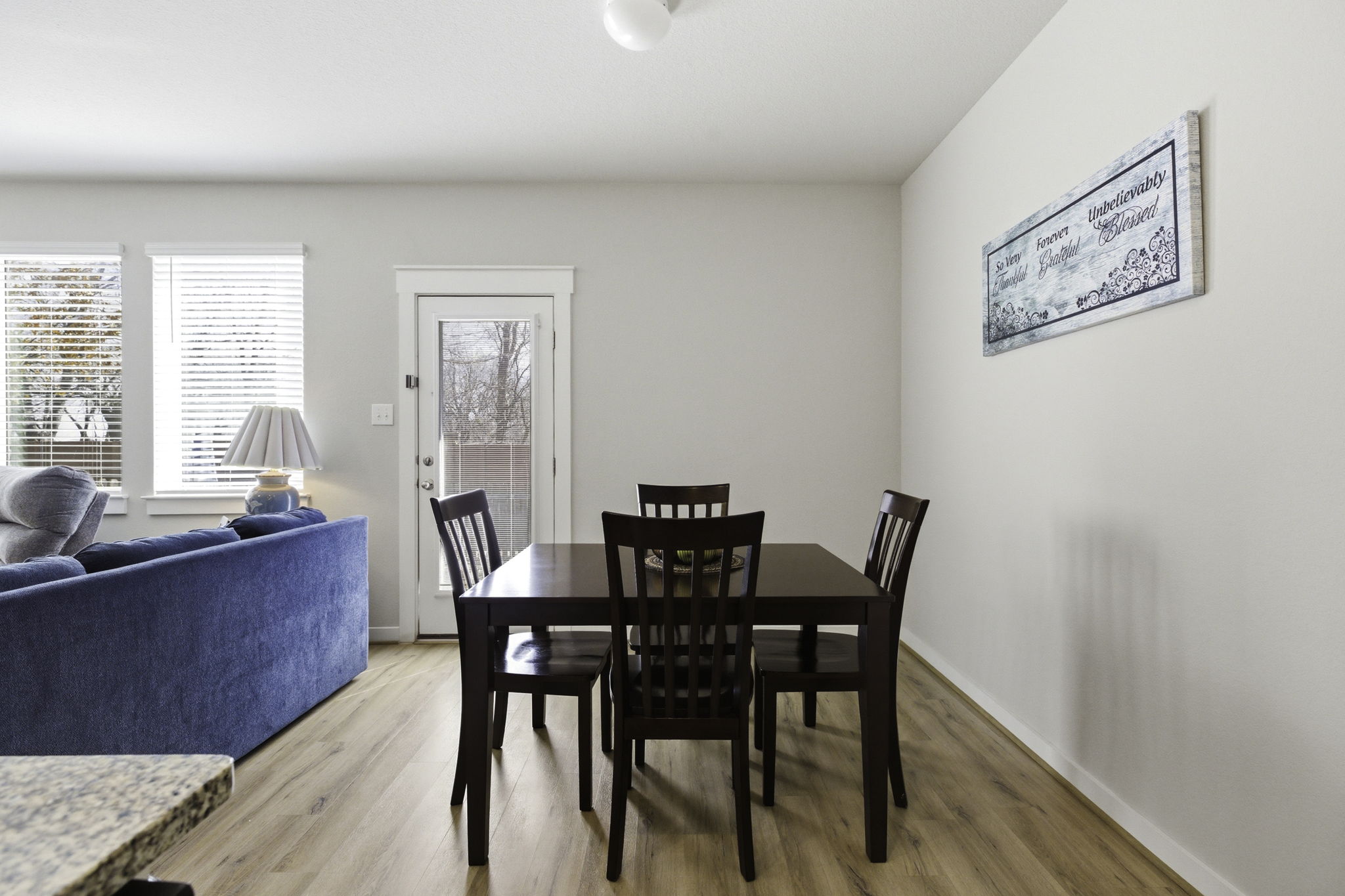17205 Leafroller Drive, Unit B Pflugerville, TX 78660 - Photo 13 of 32 a view of a dining room with furniture a livingroom and wooden floor