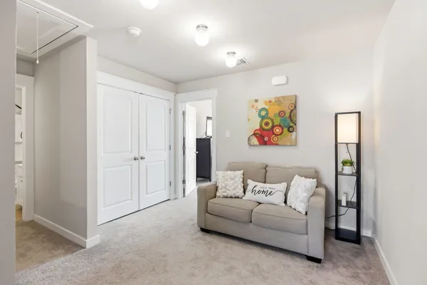 a living room with furniture and a walk in closet