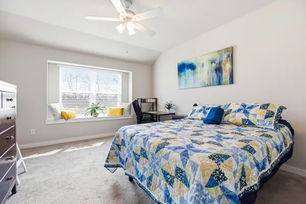 a bedroom with bed and window
