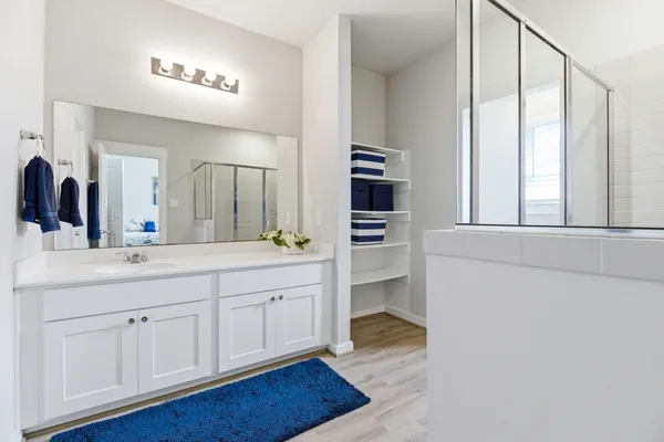 a spacious bathroom with a sink and a mirror