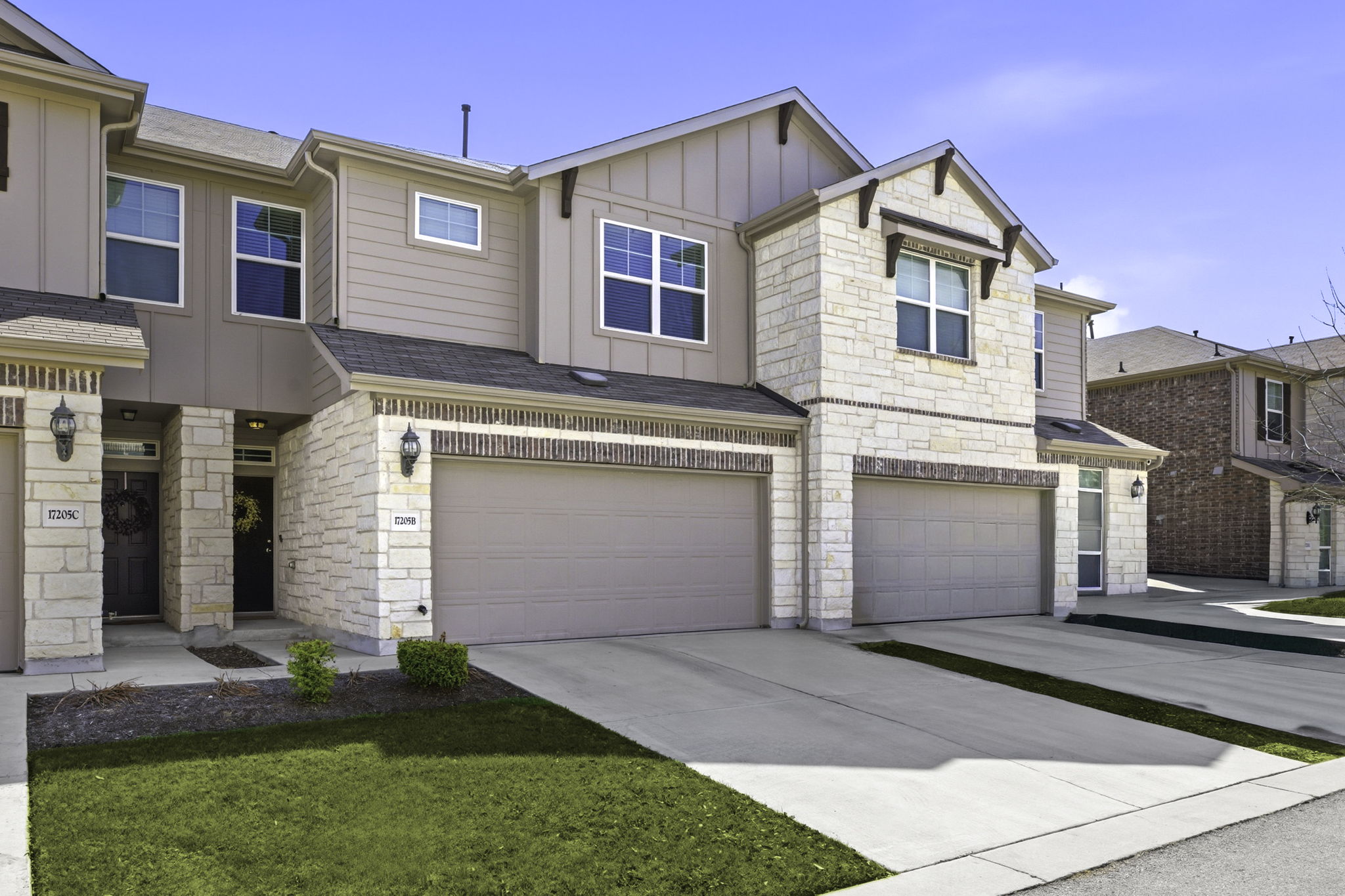 17205 Leafroller Drive, Unit B Pflugerville, TX 78660 - Photo 2 of 32 a front view of a house with a yard and garage