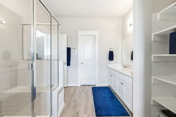 a bathroom with a granite countertop sink mirror and shower