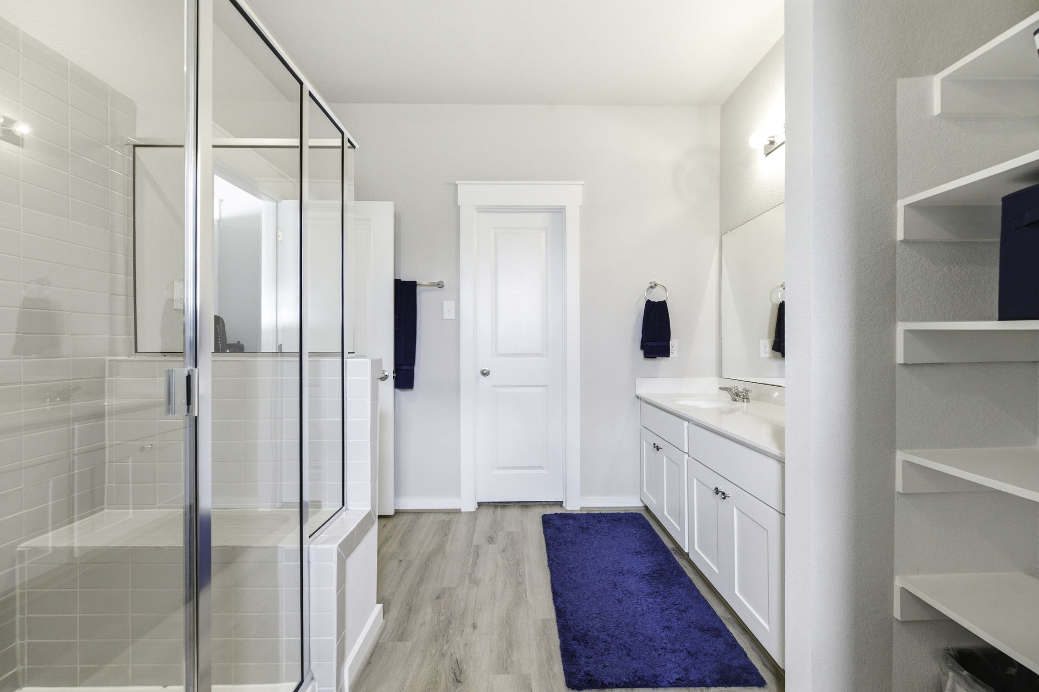 17205 Leafroller Drive, Unit B Pflugerville, TX 78660 - Photo 21 of 32 a bathroom with a granite countertop sink mirror and shower