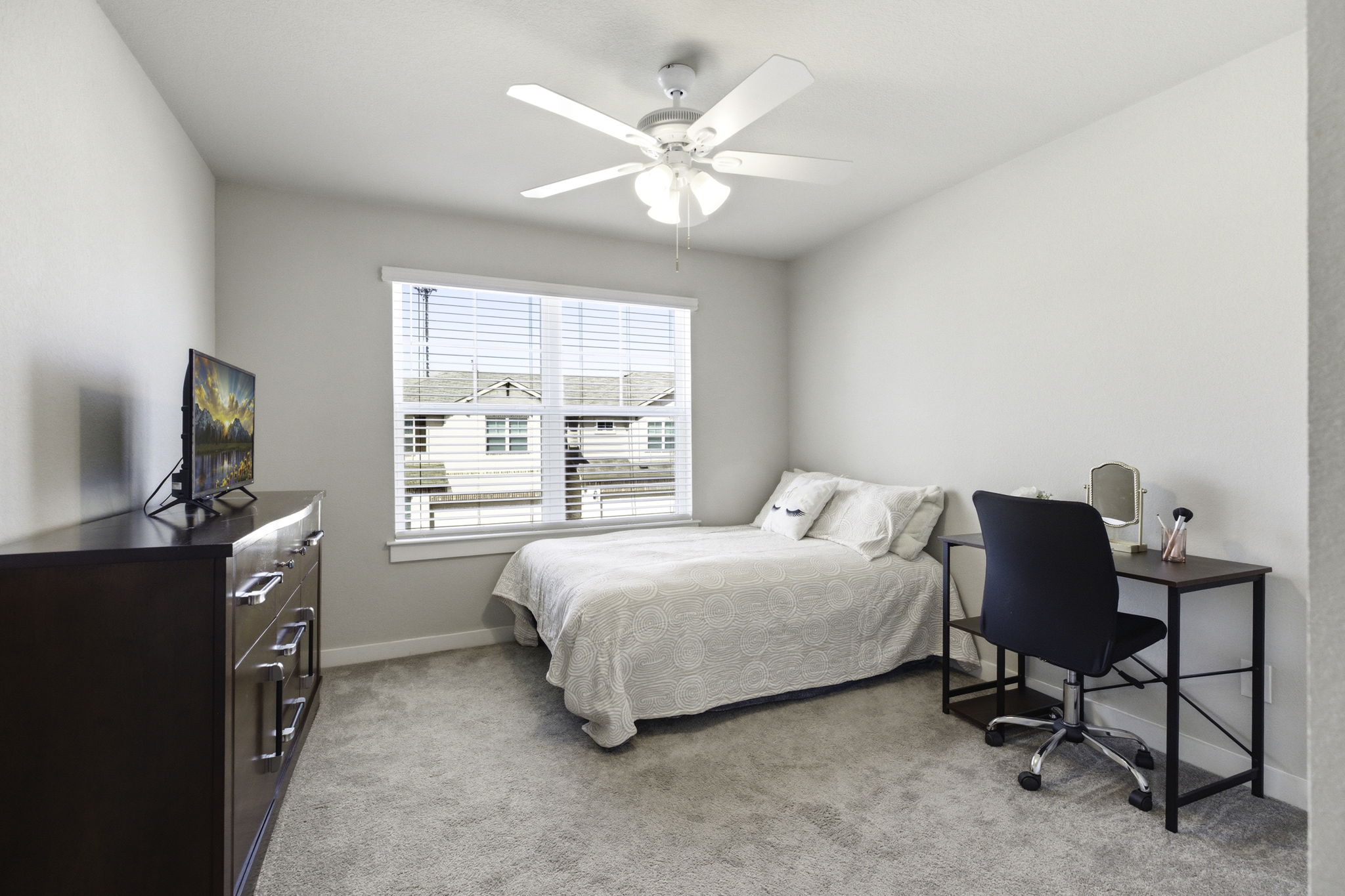 17205 Leafroller Drive, Unit B Pflugerville, TX 78660 - Photo 22 of 32 a bedroom with a bed a chair and next to a window