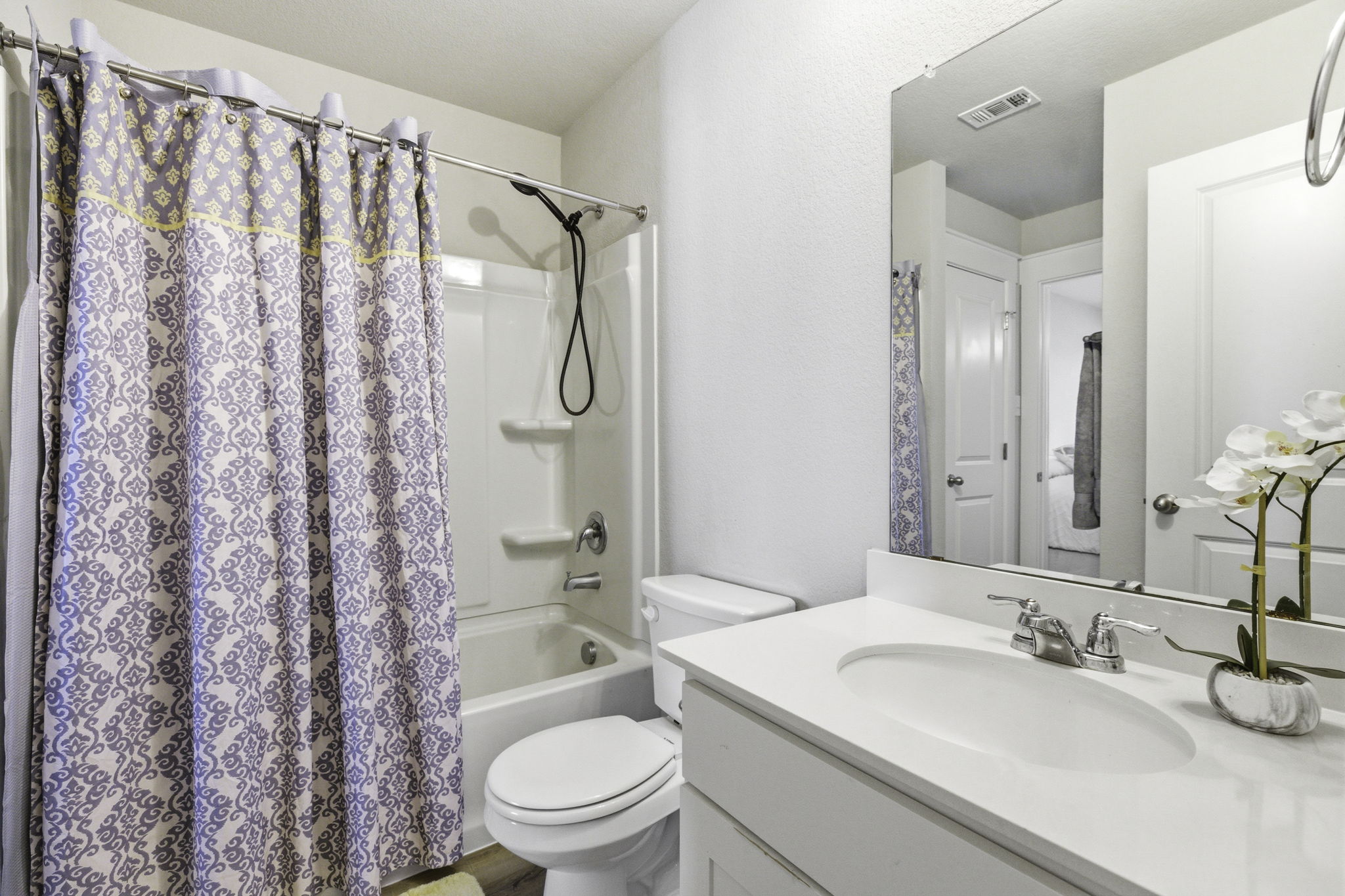 17205 Leafroller Drive, Unit B Pflugerville, TX 78660 - Photo 23 of 32 a bathroom with a granite countertop sink toilet and shower