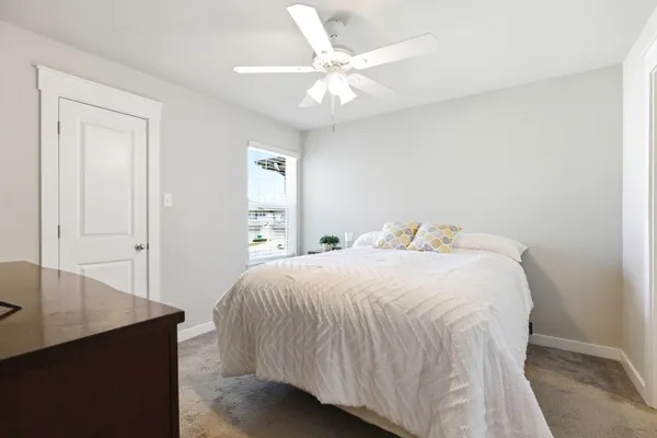 a bedroom with a bed and a table