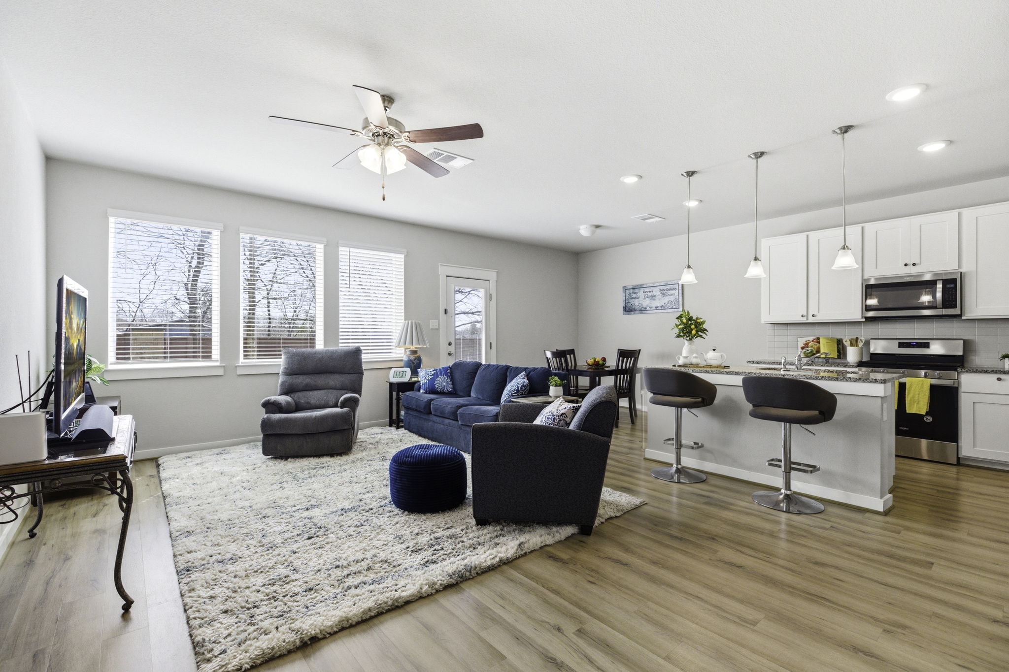 17205 Leafroller Drive, Unit B Pflugerville, TX 78660 - Photo 5 of 32 a living room with furniture kitchen view and a large window