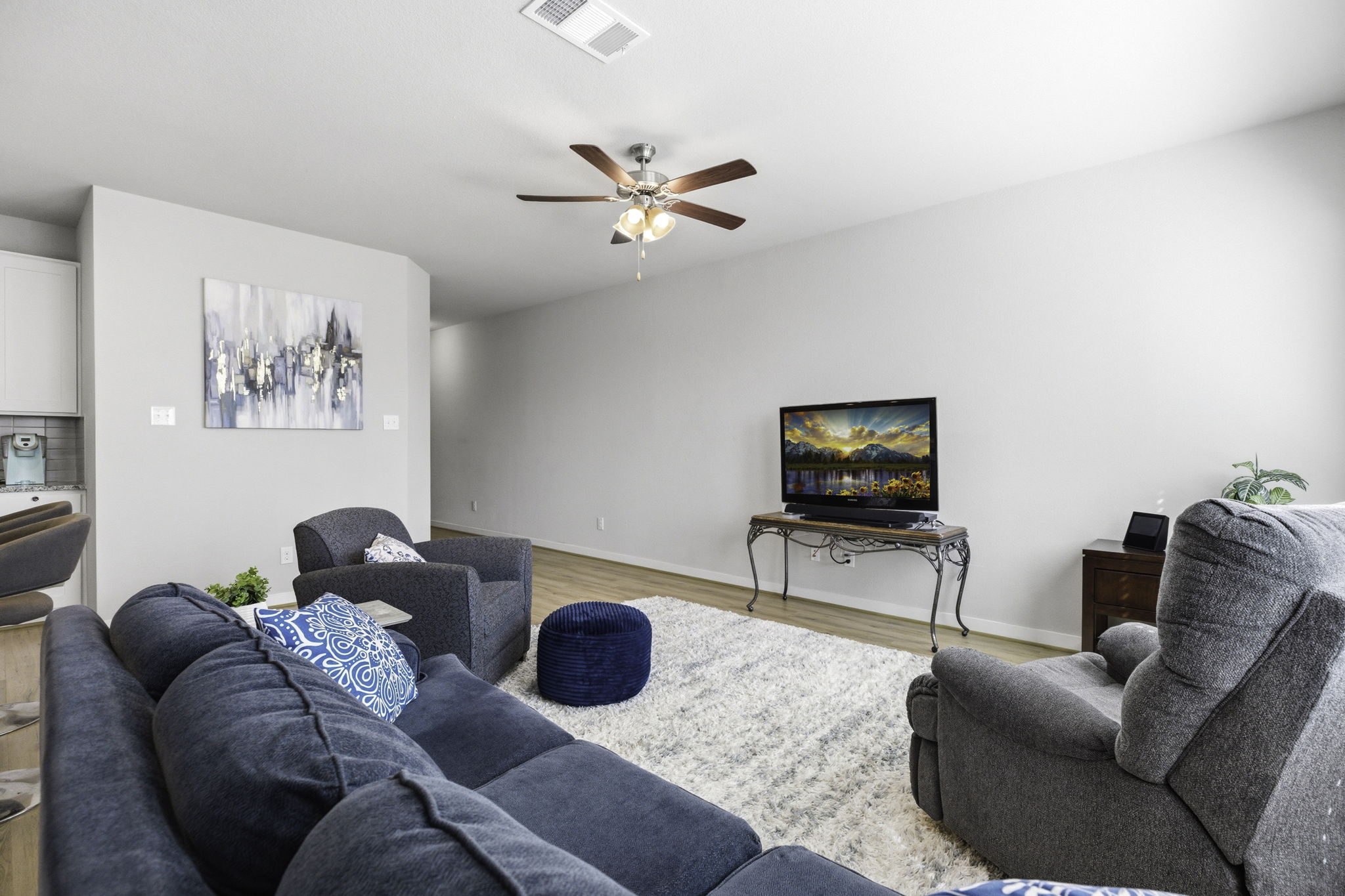 17205 Leafroller Drive, Unit B Pflugerville, TX 78660 - Photo 6 of 32 a living room with furniture and a flat screen tv