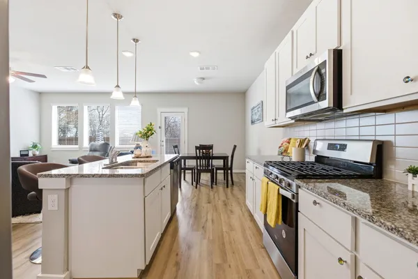 a kitchen with stainless steel appliances granite countertop a stove and a sink