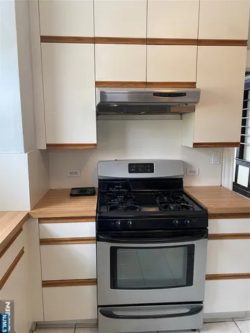 a stove top oven sitting inside of a kitchen
