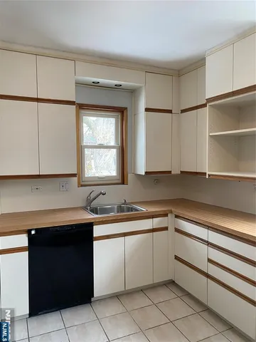 a kitchen with a sink window and cabinets