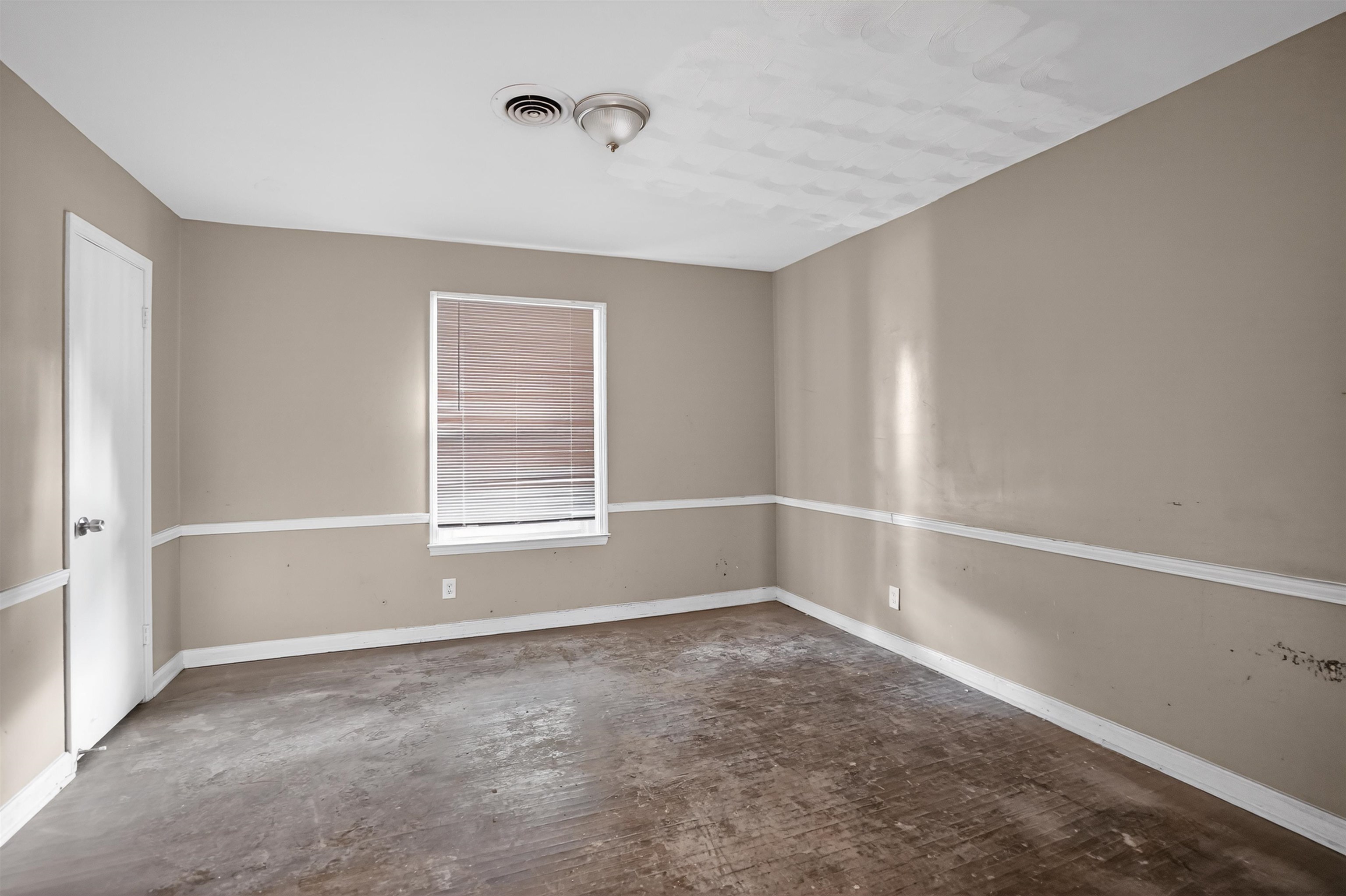 1890 Pennel Road Memphis, TN 38116 - Photo 8 of 25 Room featuring a window with blinds, light tan walls with white chair rail molding, and a flush mount ceiling light fixture