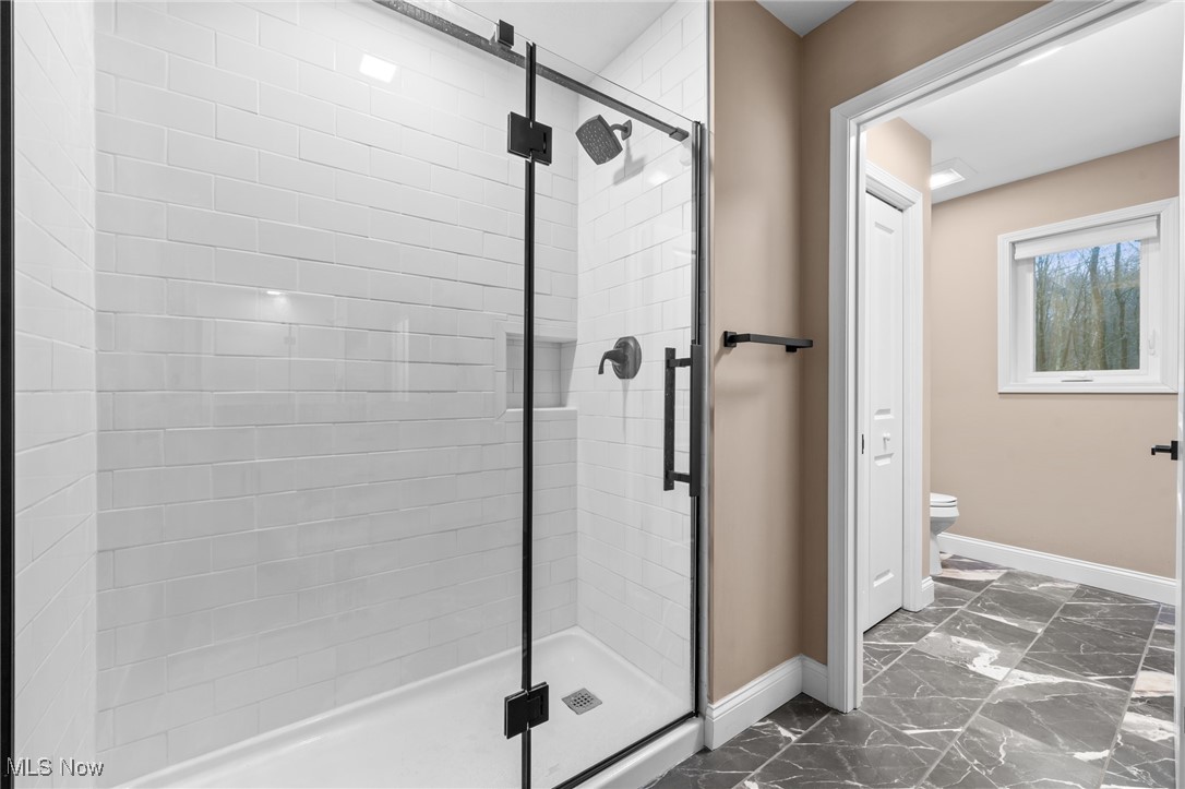 39600 Aurora Road Solon, OH 44139 - Photo 30 of 49 Full bath with dark marble finish floors and a shower stall