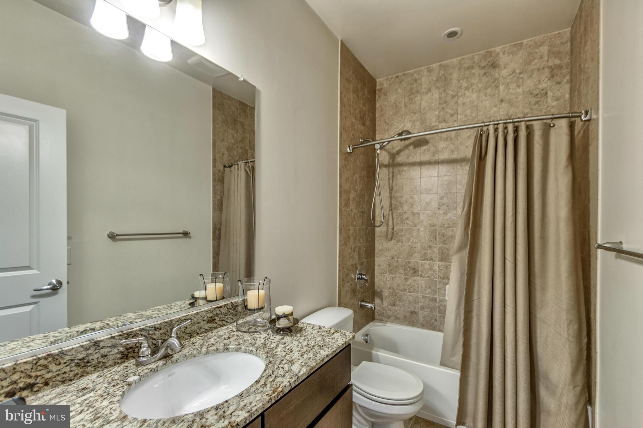 2524 Sheridan Road Southeast Washington, DC 20020 - Photo 12 of 20 a bathroom with a granite countertop sink toilet and shower