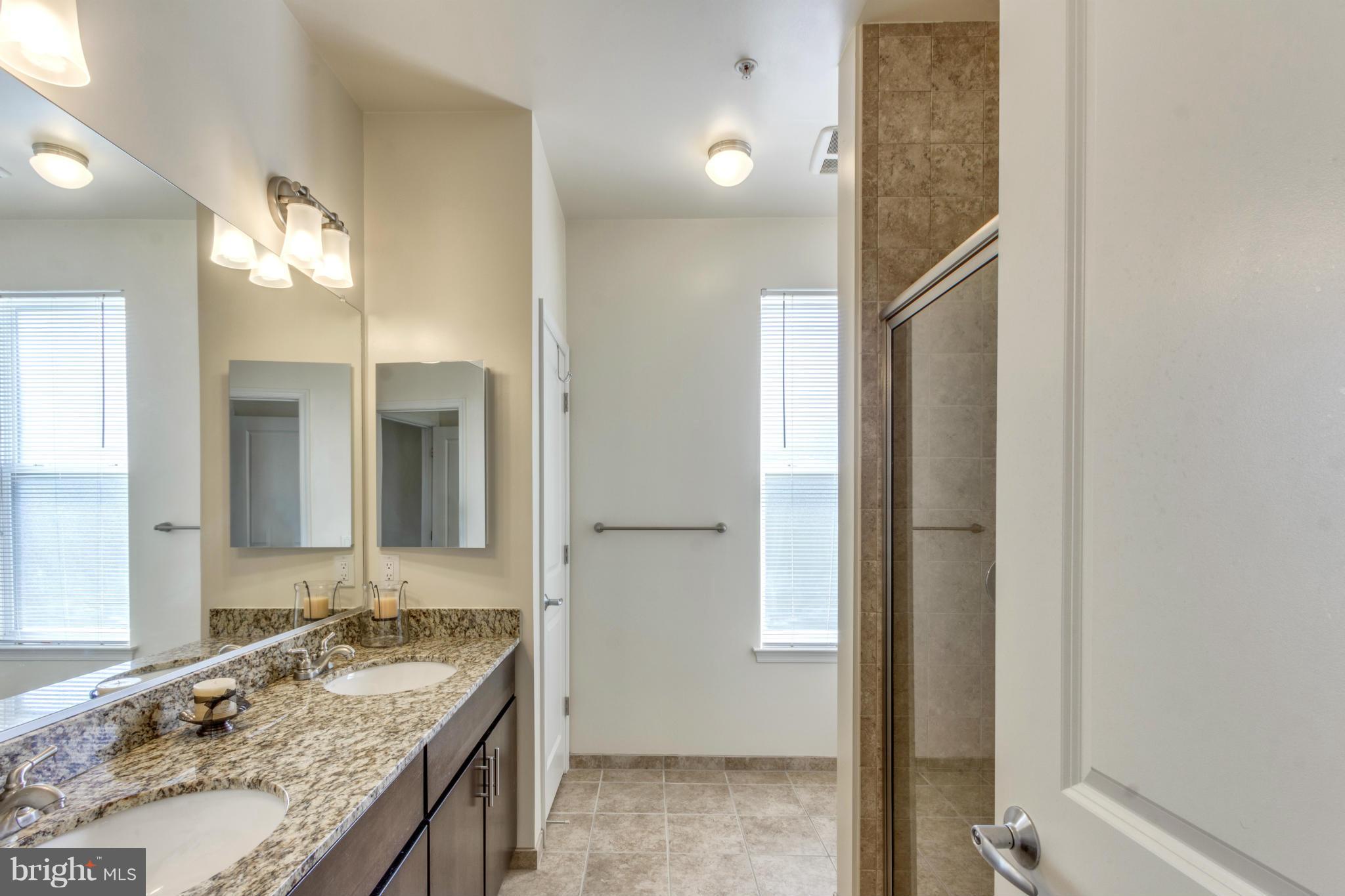 2524 Sheridan Road Southeast Washington, DC 20020 - Photo 14 of 20 a bathroom with a granite countertop sink and a mirror