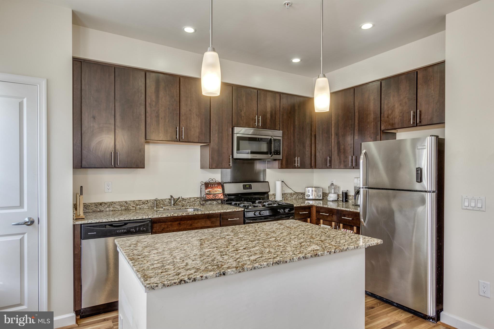 2524 Sheridan Road Southeast Washington, DC 20020 - Photo 7 of 20 a kitchen with a refrigerator a microwave a sink and cabinets