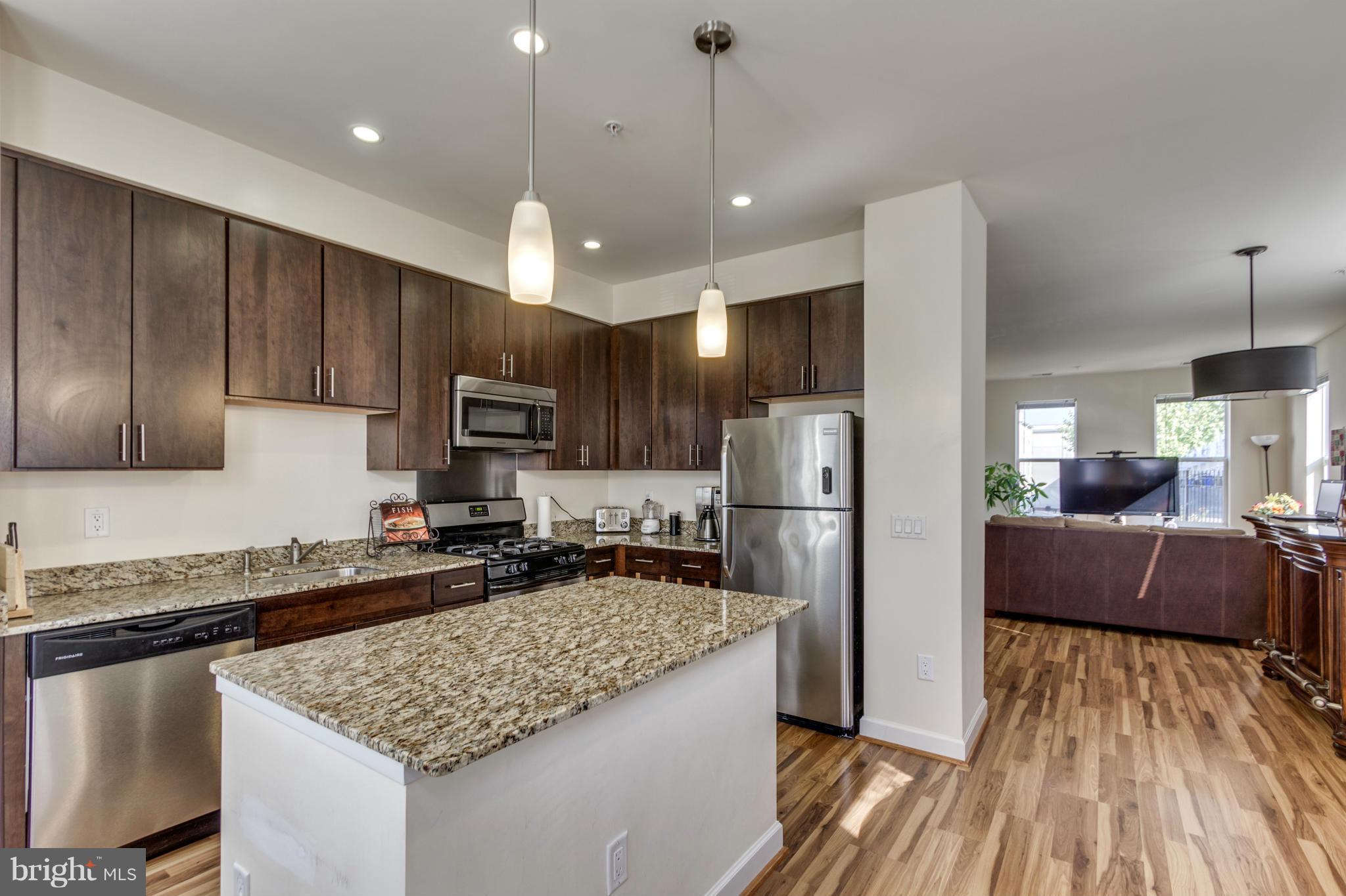 2524 Sheridan Road Southeast Washington, DC 20020 - Photo 8 of 20 a kitchen with stainless steel appliances granite countertop a refrigerator a sink dishwasher a stove and white countertops with wooden floor