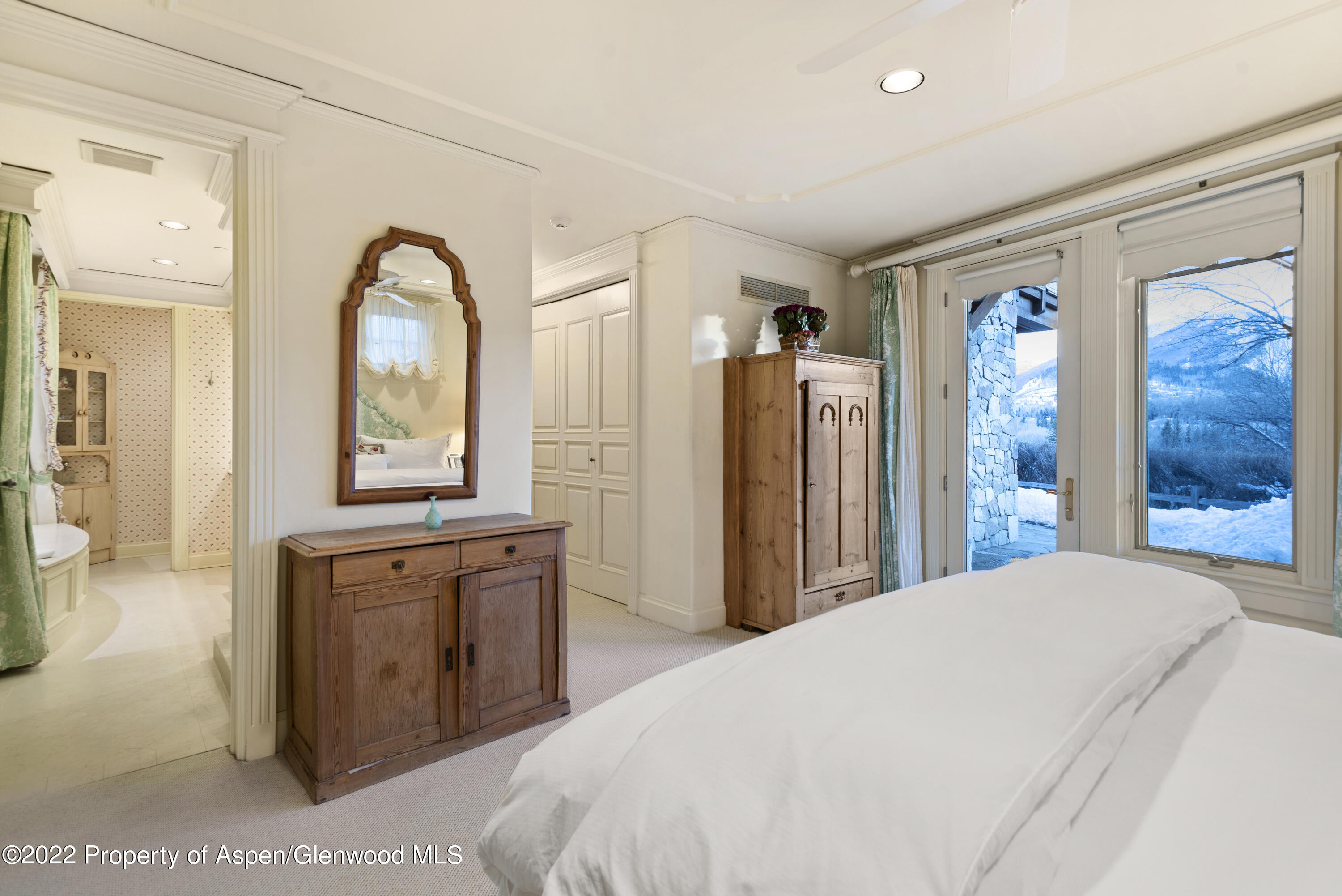 926 Willoughby Way Aspen, CO 81612 - Photo 25 of 47 a spacious bedroom with a large bed and a dresser