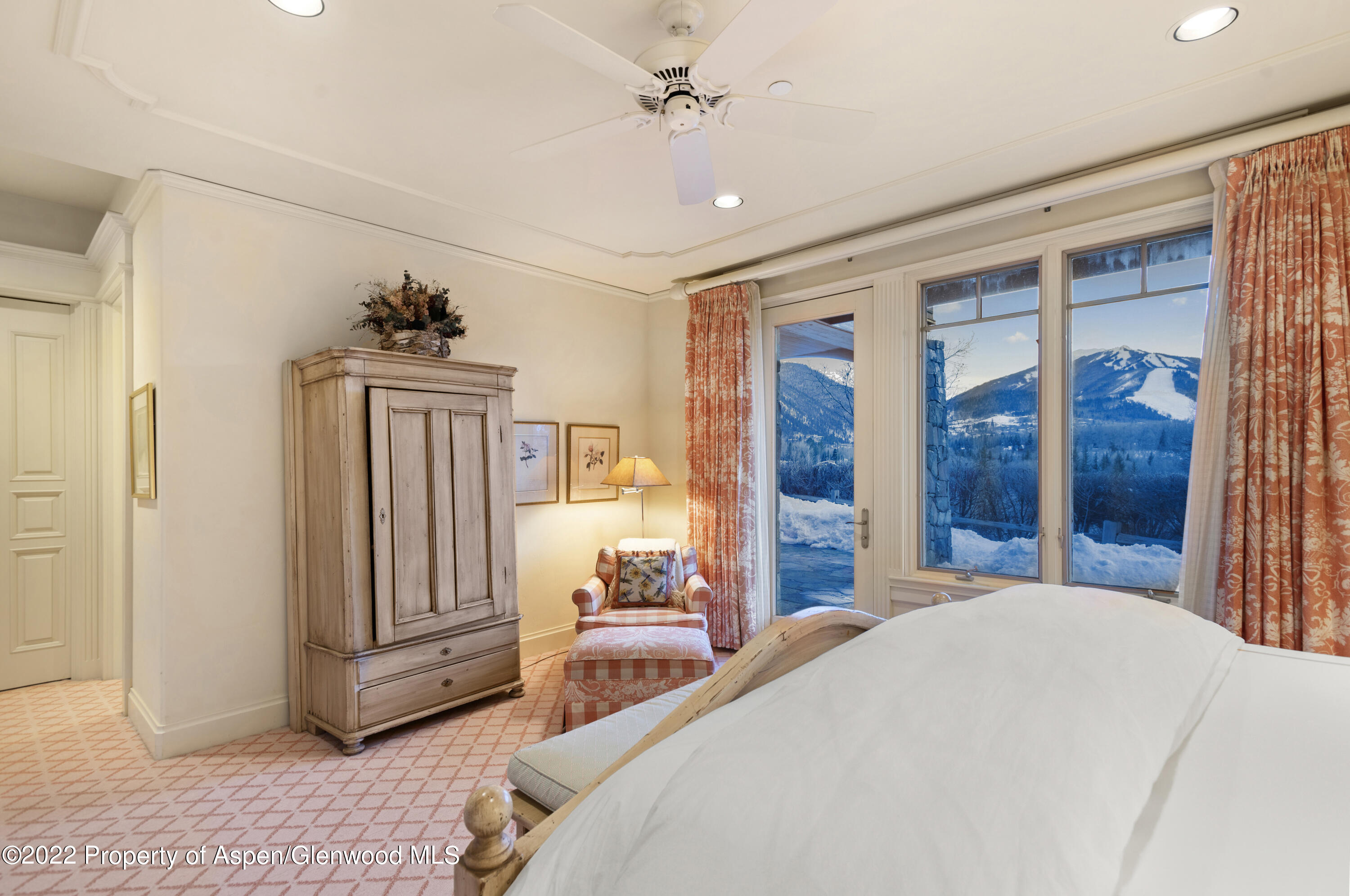 926 Willoughby Way Aspen, CO 81612 - Photo 29 of 47 a bedroom with a large bed and a chandelier