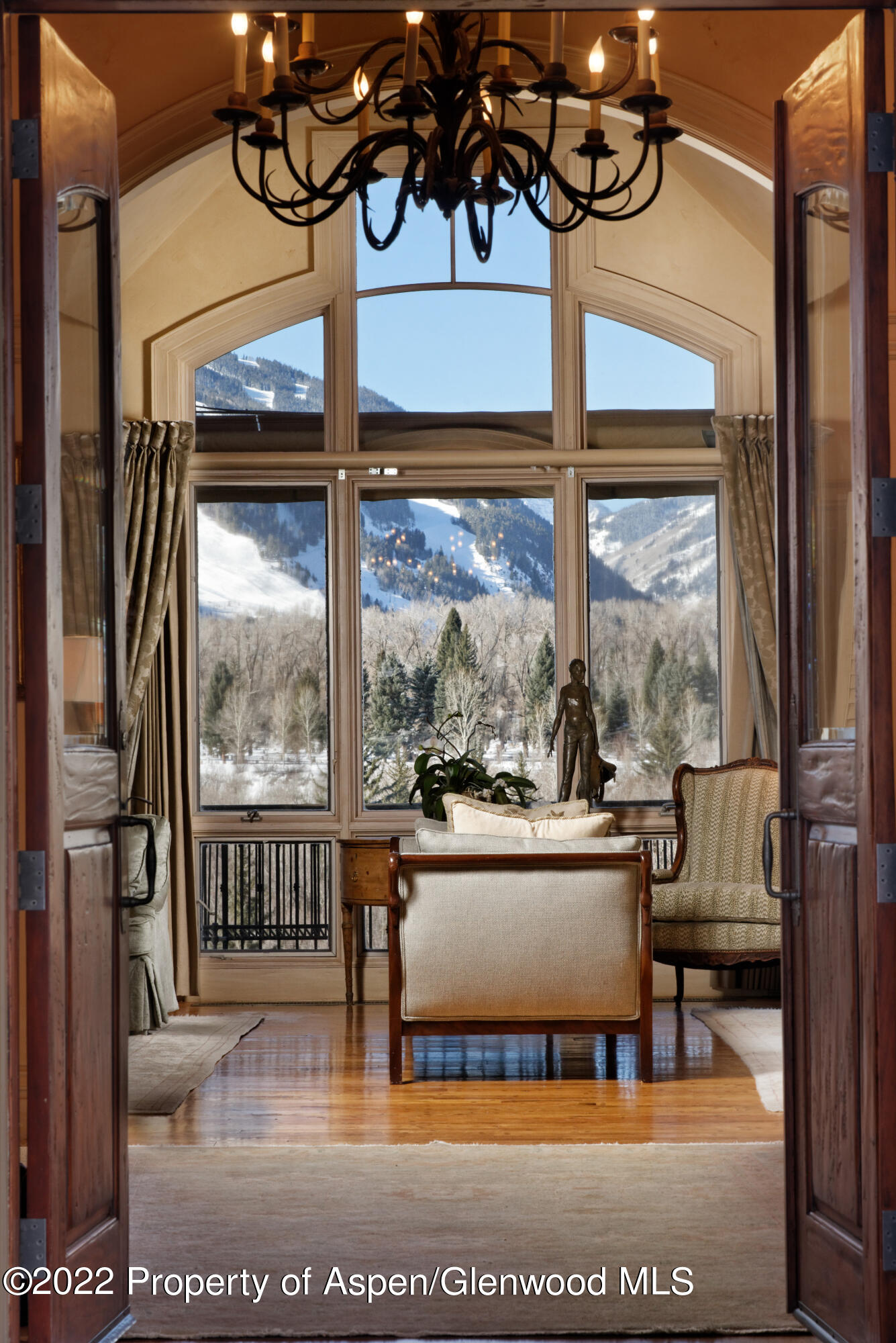 926 Willoughby Way Aspen, CO 81612 - Photo 3 of 47 a living room with large windows and a table