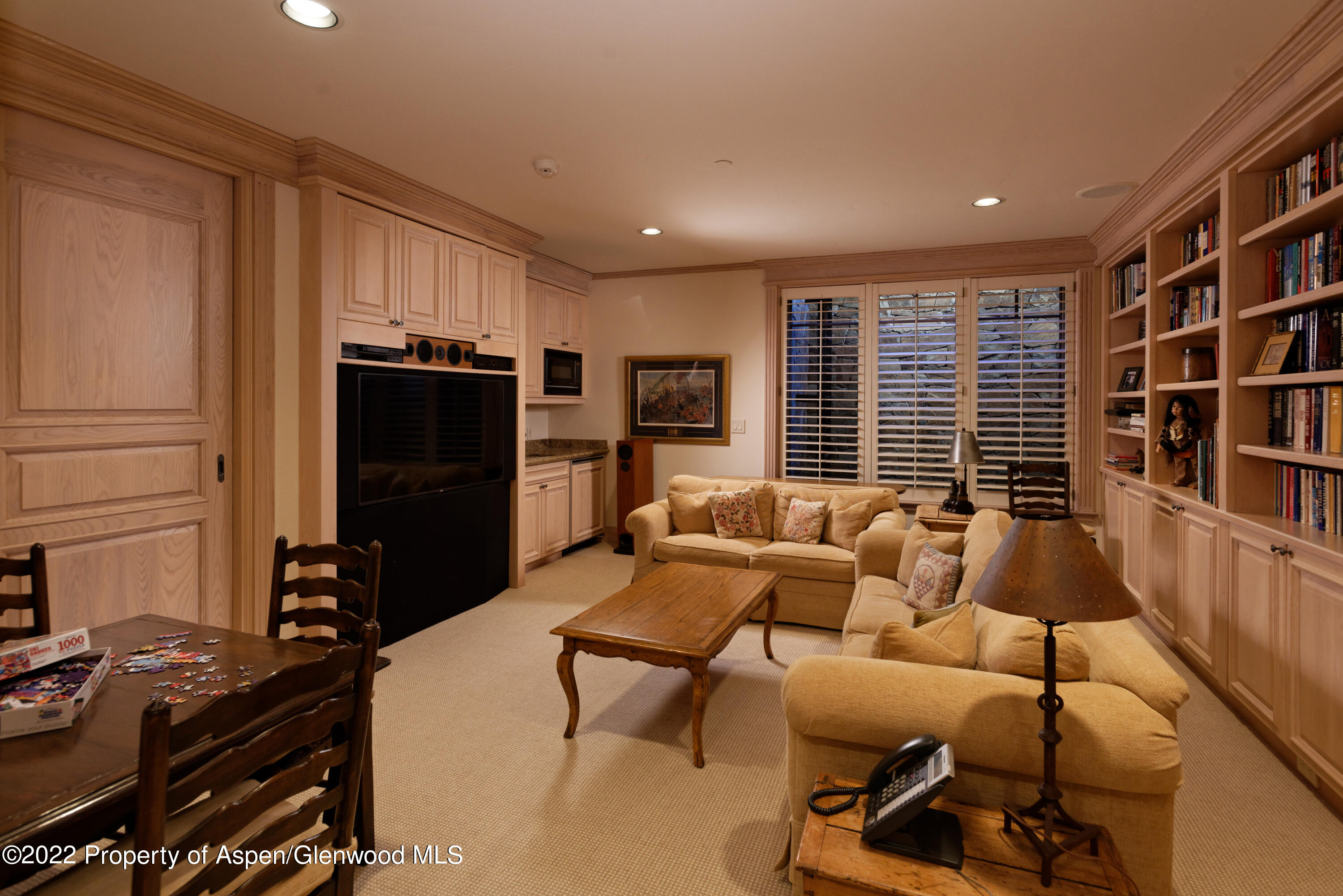 926 Willoughby Way Aspen, CO 81612 - Photo 34 of 47 a living room with furniture a large window and a flat screen tv