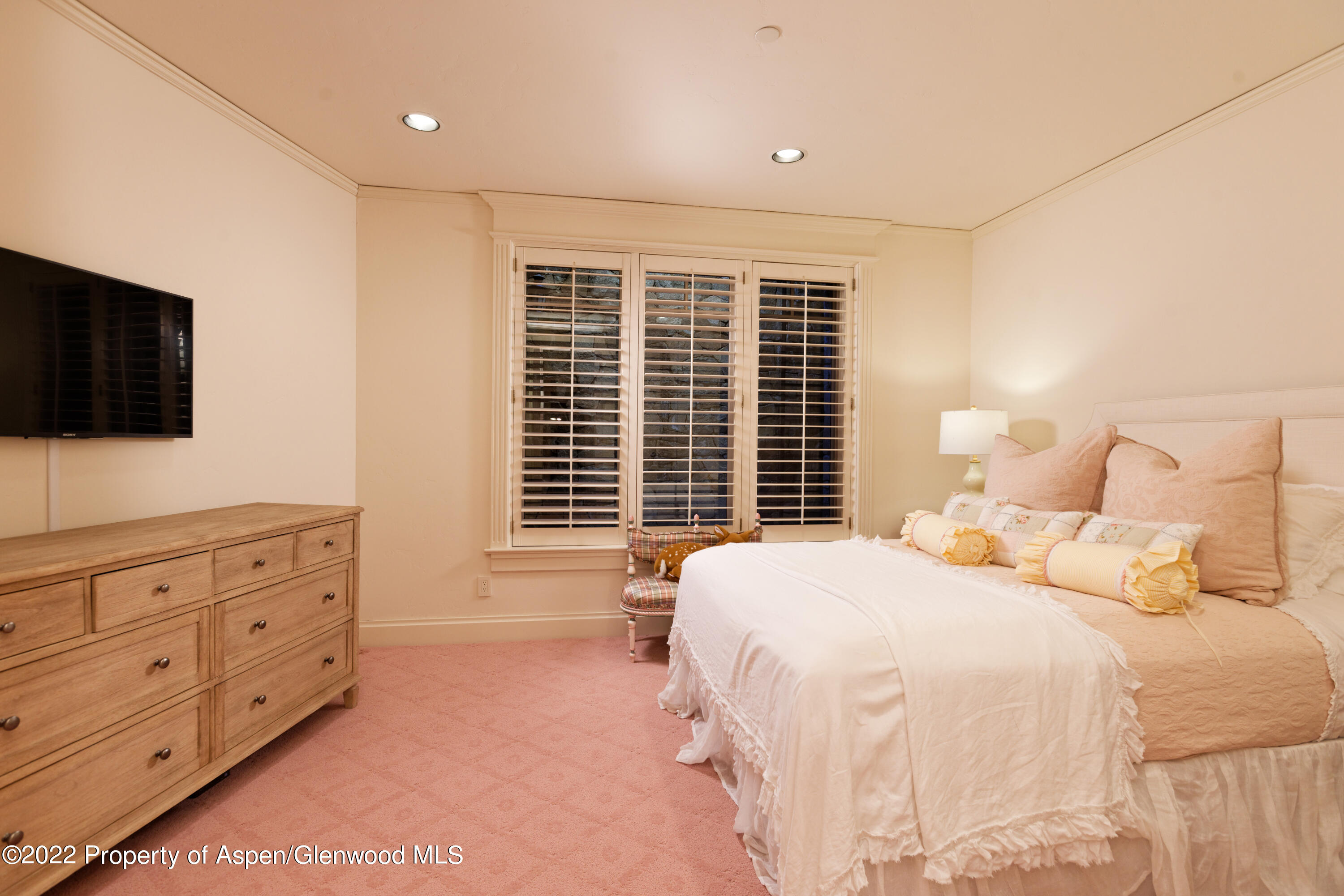 926 Willoughby Way Aspen, CO 81612 - Photo 37 of 47 a bedroom with a bed and a flat screen tv