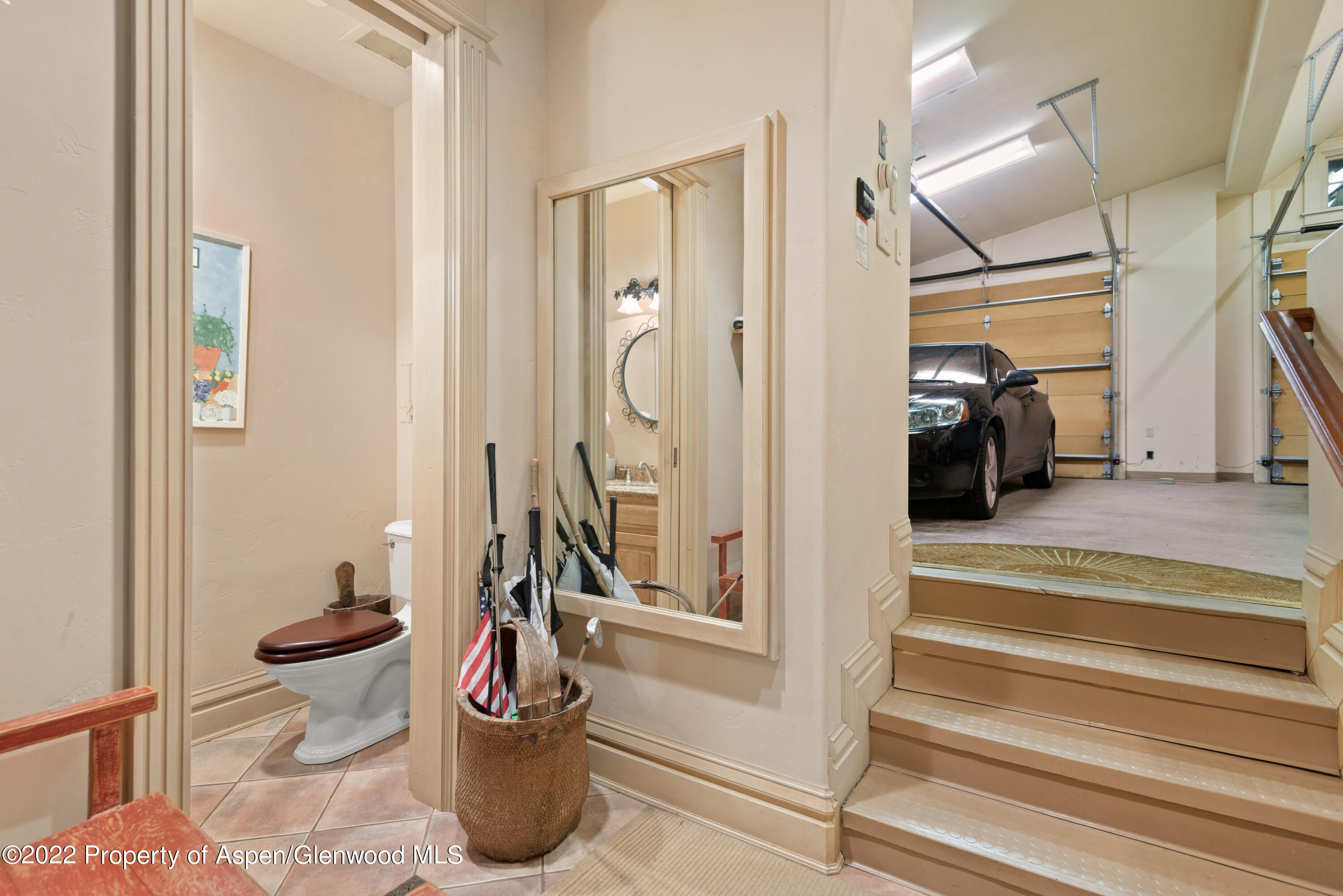 926 Willoughby Way Aspen, CO 81612 - Photo 40 of 47 a view of a hallway and a dining room with wooden floor