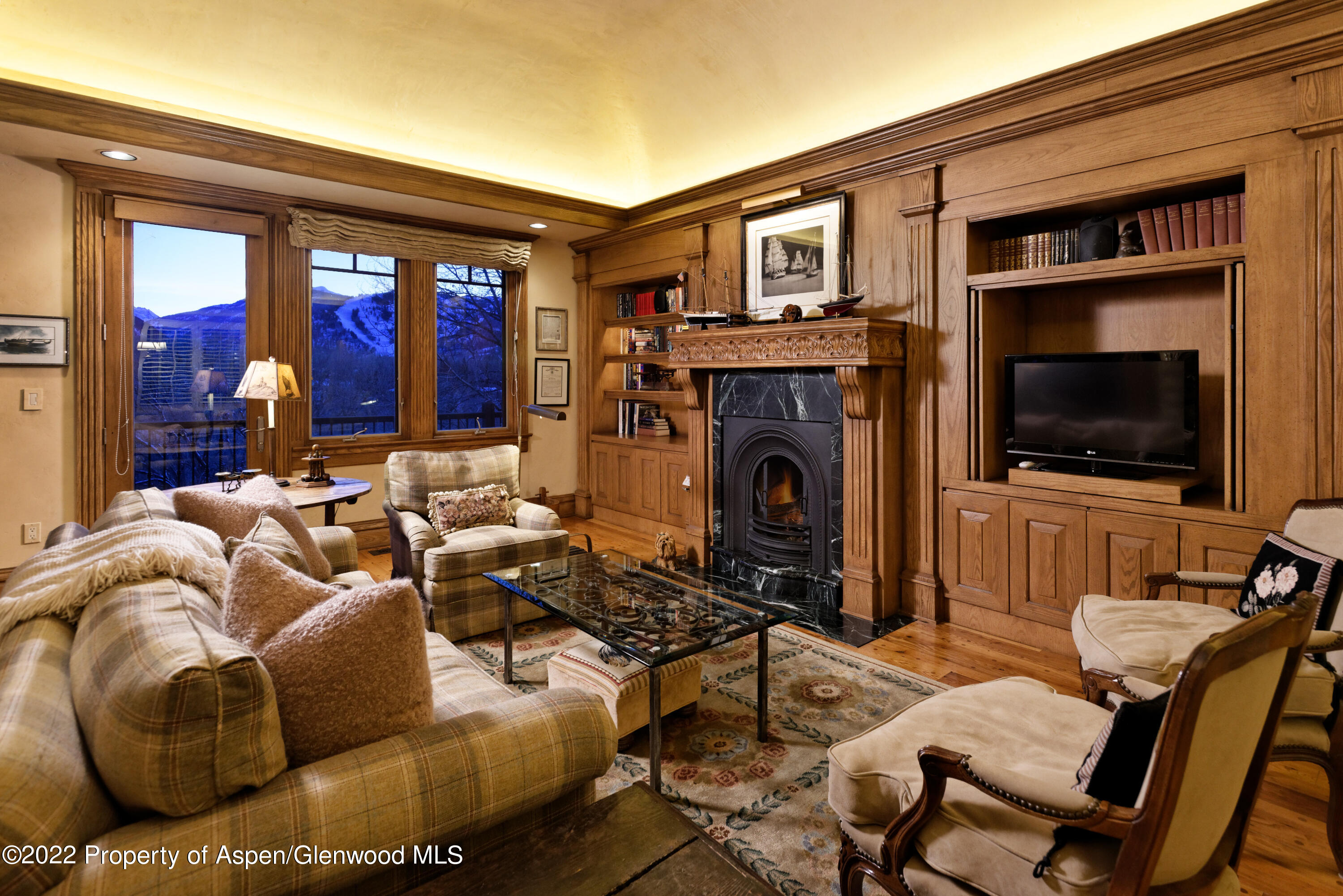 926 Willoughby Way Aspen, CO 81612 - Photo 9 of 47 a living room with furniture a flat screen tv and a fireplace