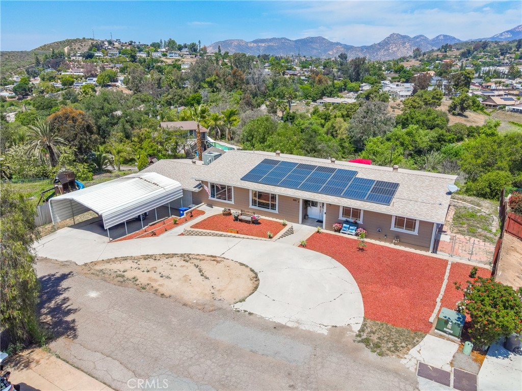 an aerial view of a house with a yard