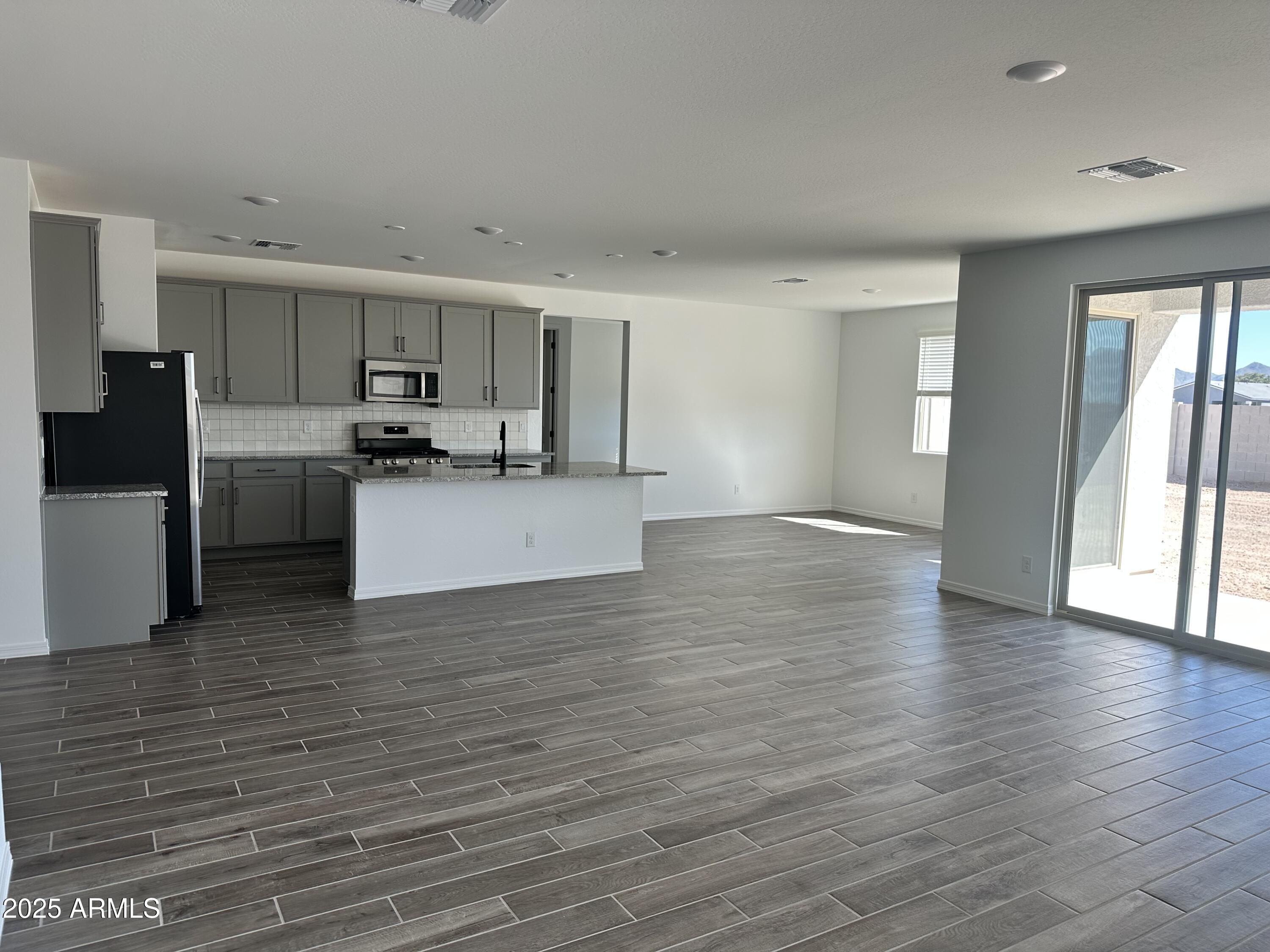 5535 West Hopi Trail Laveen, AZ 85339 - Photo 13 of 45 a view of a kitchen with wooden floor