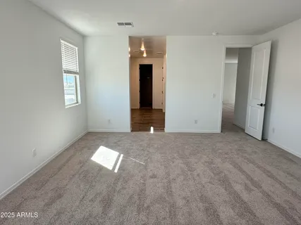 an empty room with windows and entrance