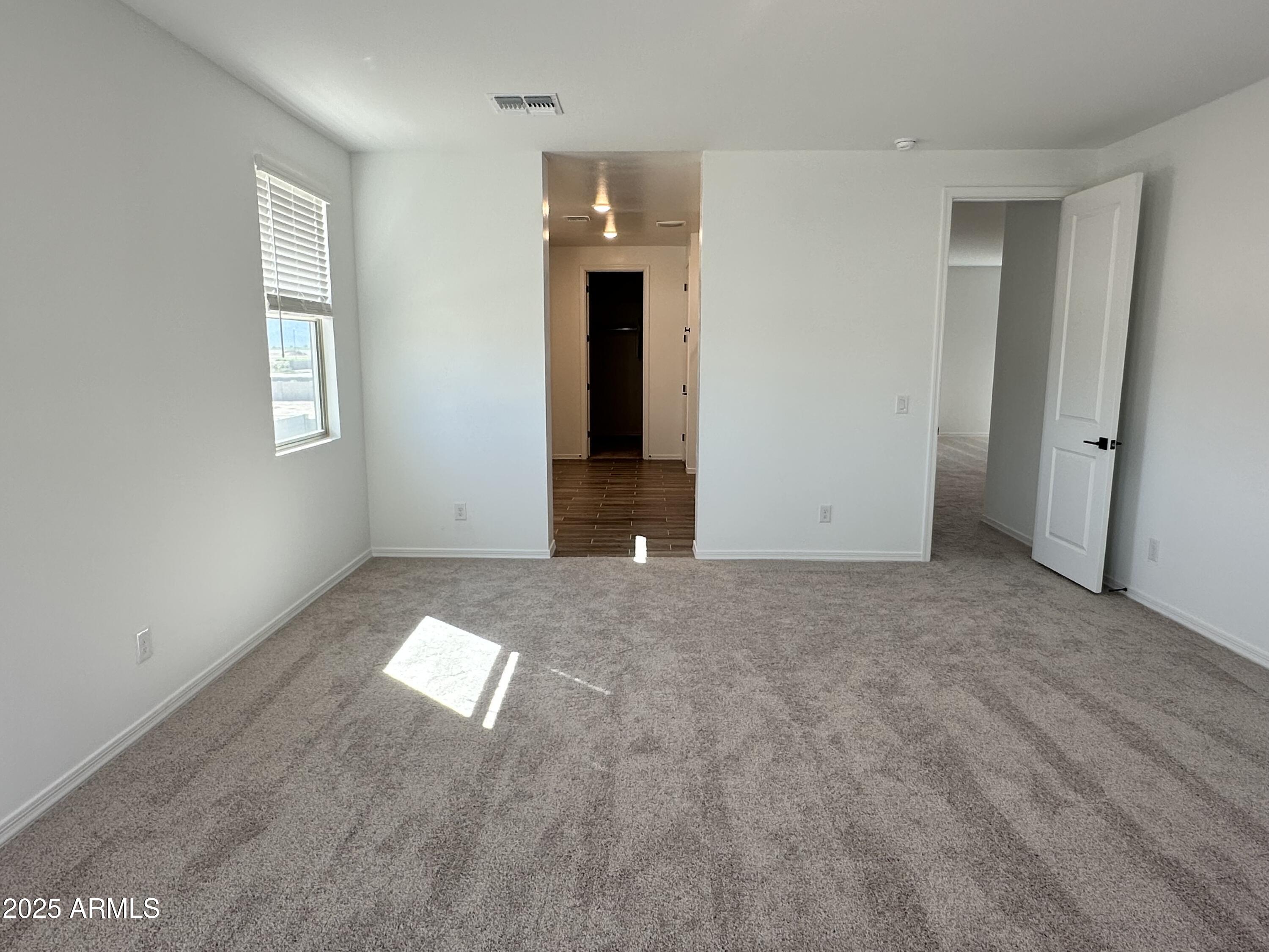 5535 West Hopi Trail Laveen, AZ 85339 - Photo 26 of 45 an empty room with windows and entrance