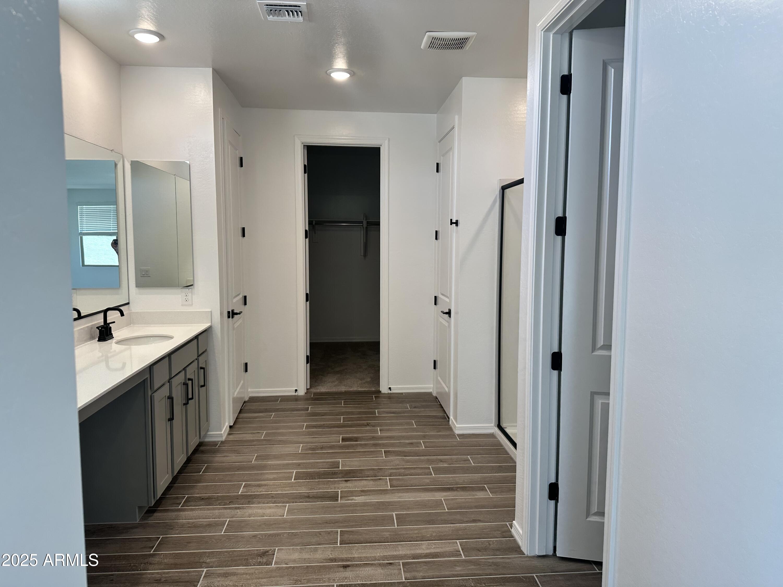 5535 West Hopi Trail Laveen, AZ 85339 - Photo 27 of 45 a large kitchen with a sink and a wooden floor
