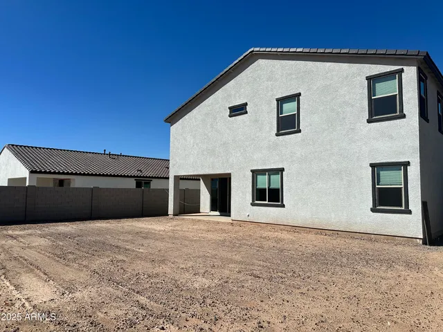 a view of a house with a backyard