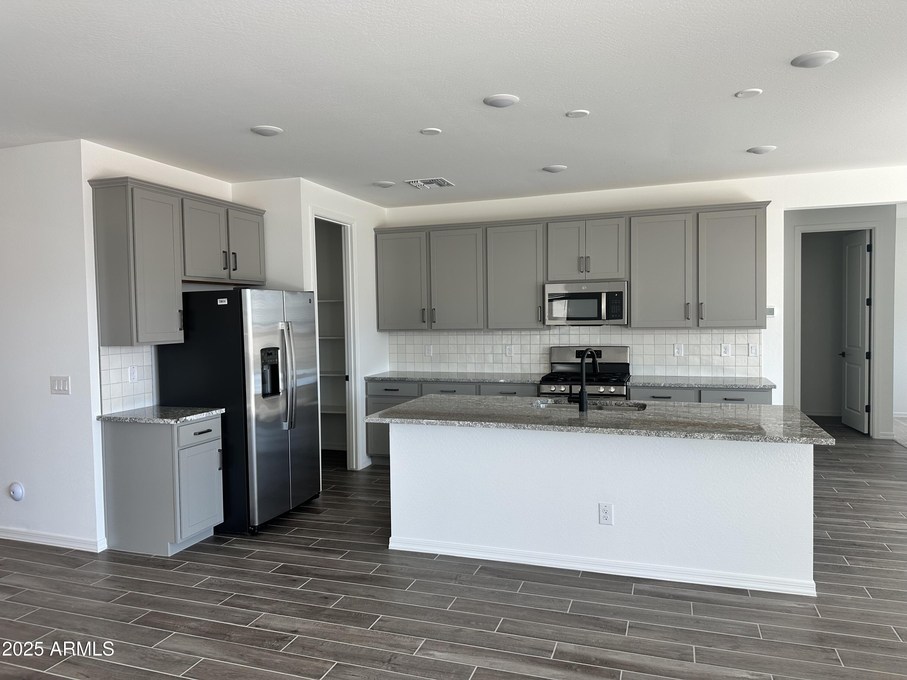 5535 West Hopi Trail Laveen, AZ 85339 - Photo 7 of 45 a kitchen with stainless steel appliances granite countertop a refrigerator and a stove top oven