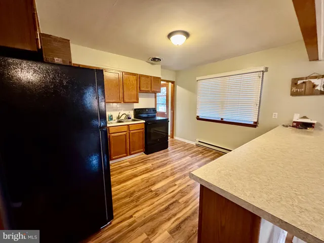 a kitchen with a sink and wooden cabinets