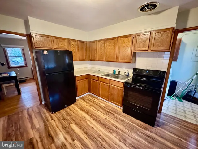 a view of wooden floor and cabinets in a room