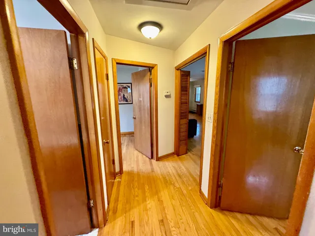 a view of a roof deck with couches and wooden fence and floor